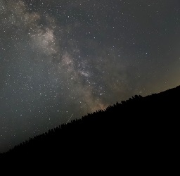The Milky Way stretches into space over the top of a ridge seen from Snoqualmie Point Park in Washington.