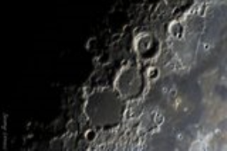 Closeup of the craters Ptolemaeus with Alphonsus, Arzachel, Albategnius and Herschel with long shadows at the edge of lunar daylight.