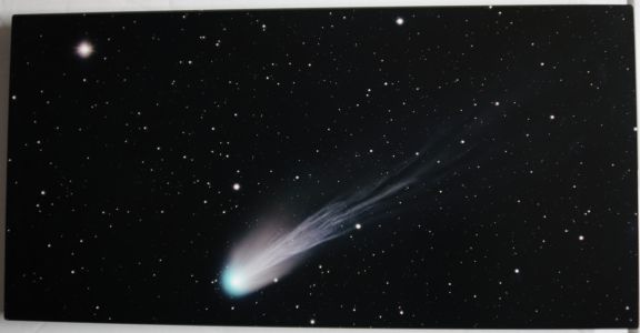 The Devil's Comet earned its nickname due to cryovolcanic activity. Explosions of gases have been observed and one image gave it a distinct horned aspect. Comet 12P/Pons-Brooks is periodic, with an orbit every 71 years, making it a Halley-type comet. This year it was especially bright. I only had a few hours to image it after dusk, so I used a fast HyperStar system from the deck of some friends with an ocean view to avoid obstructions on the horizon. The comet is known for having an amazingly long and intricately detailed tail that I believe stands out in the metal print of this capture. It is in close proximity to bright star Hamal that glows like a diamond, hence: the Devil's diamond.