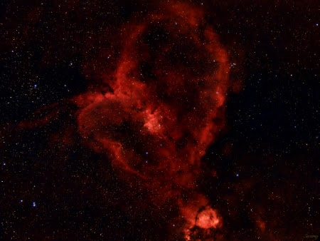 The Heart Nebula is an emission nebula that is visible due to glowing ionized hydrogen gas contrasted with lanes of dark dust. IC1805 hangs out next to Cassiopeia with its companions, the nearby Soul Nebula and the visually intersecting Fish Nebula. This image was captured with only a few minutes of exposure using a dualband seven-nanometer filter for Hydrogen Alpha and Oxygen II. The  Optolong L-eXtreme effectively filtered out light pollution while letting in the light emitted by Hydrogen Alpha to produce a dazzling image in a short period of time.