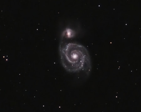 Due to its position high in the  sky in the Northern Hemisphere, M51 or the Whirlpool Galaxy is in a prime viewing location and stays there all night. This makes it a popular target for galaxy hunters. The beautiful spiral galaxy is energized by the gravitational pull of the nearby spherical galaxy that is believed to have passed completely through it long ago. This energy is a catalyst for the rapid formation of new stars that illuminate the well-defined arms of  the galaxy. A three hour exposure brings out soft colors and the faint, wispy veil of nebulosity that surrounds the galaxy.