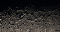 Along the edge of shadow splitting the moon from north to south is a line of magnificent craters. Large and left is Manganus. Top middle is the large Deslandres, pounded by several other craters that have deformed its shape. The pair of almost perfect circles to the right with peaks in the middle are Arzachel and Alphonsus.