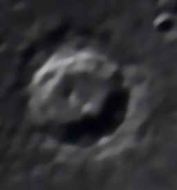 A close up of the crater Eratosthenes (bottom left). It has a terraced rim and peaks inside the crater where the well drops to a depth of nearly 2 miles.