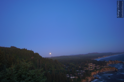 The full moon rises over the Oregon coast.