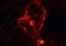 The star cluster Melotte 15 contains bright young stars that energize hydrogen, causing it to emit the red light that illuminates this heart-shaped nebula. In the corner is its near companion Fishead Nebula.