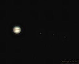 This is a capture of Jupiter and three moons (from left right): Io, Europa, and Ganymede.