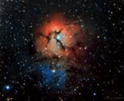 Trifid means 'three lobe' and refers to the illusion created by a wispy dark nebula spidering across the face of a more distant emission nebula.