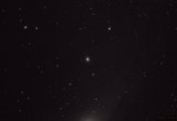 Just off the edge of the Andromeda Galaxy is one of two satellites orbiting the Milky Way's neighbor: M32, a dense cloud of stars that are classified as a dwarf, early-stage compact elliptical galaxy.