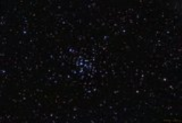 Like a cousin to the Seven Sisters, M36 is an open cluster of young, blue stars that is far more distant than the Pleiades. Called the Pinwheel Cluster, it is a region of contrast with neighboring red stars.