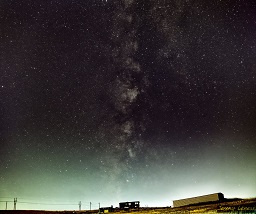 The Milky Way looms over a field by the Paint Mines in Colorado.
