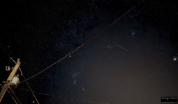 I set out my camera and programmed it for 25-second exposures to run all night long. I love to see videos made from timelapses like this, but I also was in search of a meteor. The Leonids are reaching their peak and indeed I captured one oriented in the direction of faraway constellation Leo. I believe the green indicates a good amount of magnesium, or maybe it's just chromatic aberration. The meteor chose a terrific frame to appear in. Orion fits perfectly between the two power lines. Aldebaran blazes brightly just below the green streak of metals burning in the atmosphere. The meteor is a Leonid, as an imaginary line drawn through it would terminate near the constellation Leo. As a bonus, the bright white object just about to exit the stage right is none other than Jupiter.