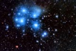 My favorite signal of winter is the magical faint glow that glimmers in your peripheral vision but fades to a blur when you gaze head on. Magnification reveals several bright blue stars burrowing through long filaments of ionized gas and dust. The brightest of these are the famed Seven Sisters or Pleiades.